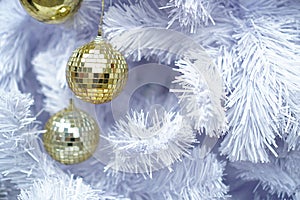 Golden disco Christmas balls decoration on white fir tree, Winter celebration Christmas and new year festival.