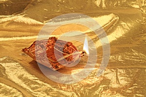 Golden Diwali - Handmade Diya in gold background