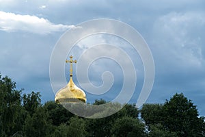 Golden dome of a church on a cloud background
