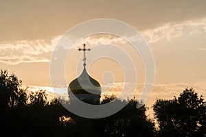 Golden dome of a church on a cloud background