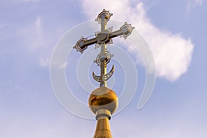 Golden dome with a cross against the sky. Orthodox cross in the blue sky. Christianity. Religion. Orthodox Christianity. Jesus.