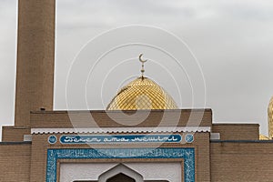 Golden dome with a moon on the Central Beket Ata Mosque in the city of Aktau.