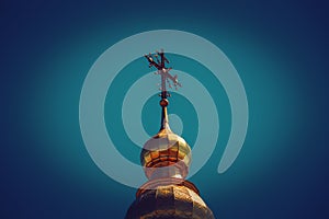 Golden domes and crosses against the blue sky.