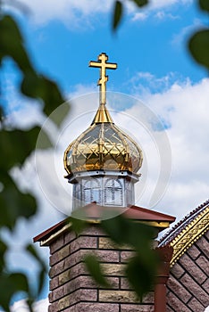 Golden domes and crosses of the orthodox church on a blue sky background