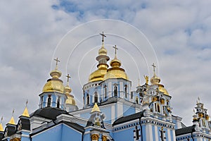 Domes of a church against a blue cloudy sky - namely St Michael\'s church in Kyiv. photo