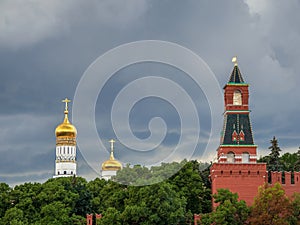 Golden domes of the old Cathedral in the Moscow Kremlin before a downpour