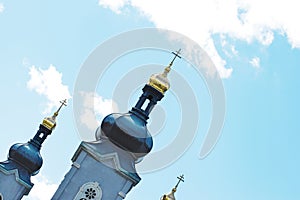 Golden domes of the temple against the blue sky