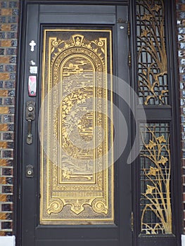 Golden door at Doejae Catholic Church. The first hanok-style catholic church built in South Korea