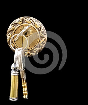 Golden door lock with the keys, isolated in black