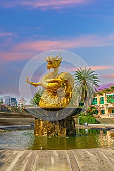 Golden dragon in old phuket town phuket Thailand this dragon is on the middle of a big water pond