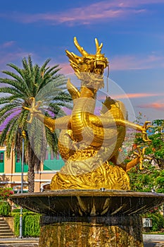 Golden dragon in old phuket town phuket Thailand this dragon is on the middle of a big water pond