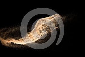 Golden dry river sand explosion isolated on white background. Abstract sand splashing