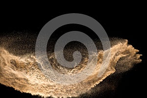 Golden dry river sand explosion isolated on white background. Abstract sand splashing