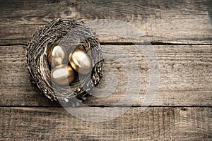 Golden easter eggs on wooden background