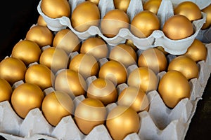 Golden eggs in a tray, Easter, success, prosperity concept