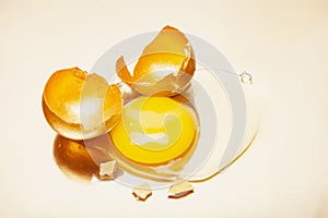 Golden eggshell placed on surface on reflective table