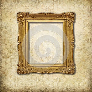 Golden empty frame on a grunge wall