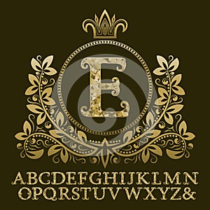 Golden encrusted letters and initial monogram in coat of arms form with crown. Royal font and elements kit for logo