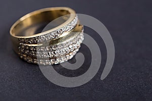 Golden engagement ring on the gray background