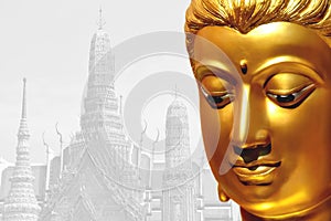 The golden face of the old Buddha statue with temple backdrop in