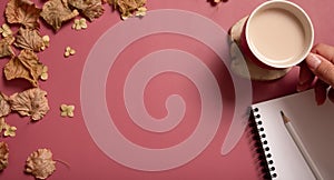 Golden fall autumn leaves, cocoa cup with female hand and note on pink background. Autumn concept, fall background with