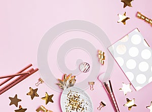 Golden festive decor and feminine accessories on the pink background