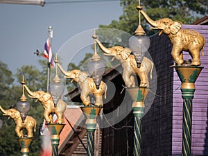 Golden Fighting Elephants Statue on Top of The Pillar in The Purple Town