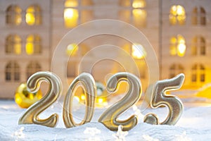 Golden figures number 2025 against the background of cozy windows of a house with warm light with festive decor of stars,snow and