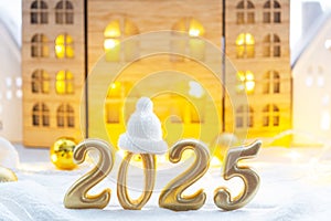 Golden figures number 2025 against the background of cozy windows of a house with warm light with festive decor of stars,snow and