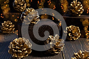 Golden fir cones on a dark background. Christmas, New Year concept. Poster, banner