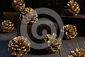 Golden fir cones on a dark background. Christmas, New Year concept. Poster, banner