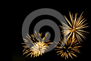 Golden fireworks border on the black sky background