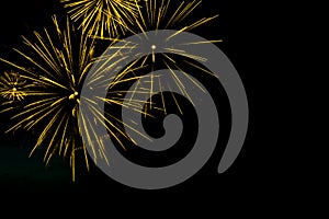 Golden fireworks border on the black sky background with copyspace