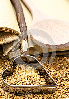 Golden flax seeds with cookbook and heart