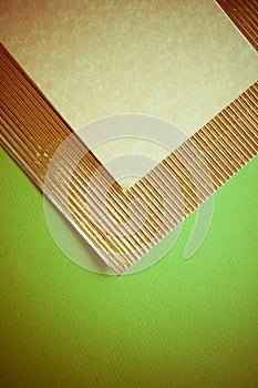 Golden flutted paper on green