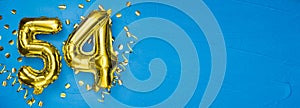 golden foil balloon number fifty four. Birthday or anniversary card with the inscription 54. blue concrete background