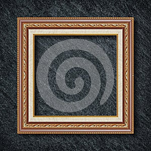 A golden frame on Dark grey black slate background or texture