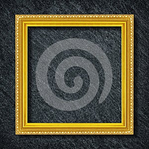 A golden frame on Dark grey black slate background or texture