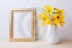 Golden frame mockup with yellow rosinweed flowers in vase