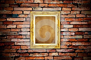 Golden frame on old brick wall