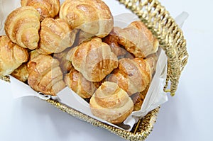 Golden fresh croissants served in wooden basket.white background