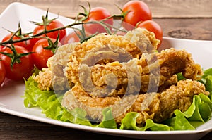 Golden fried chicken strips in breading