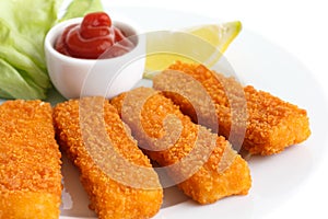 Golden fried fish fingers with lemon and tomato sauce