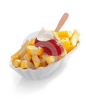 Golden fried potato chips with ketchup and mayo