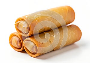 Golden fried spring rolls stacked on a white background