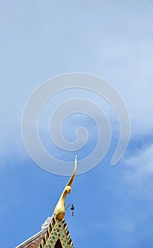 Golden gable apex on Buddhist church in Thailand