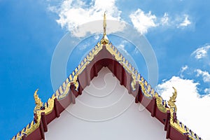 Golden gable apex on the roof of Thai temple