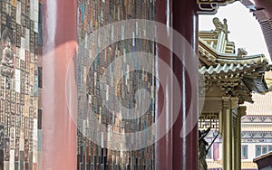 Golden gable roof and slab of colored tiles on temple wall at Fo Guang Shan Thaihua Temple