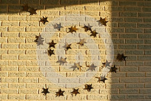Golden garland of stars on brick wall