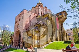 Golden Gate - ancient fortification building monument from times of Kievan Rus in side view of spring photo in frame of green gras